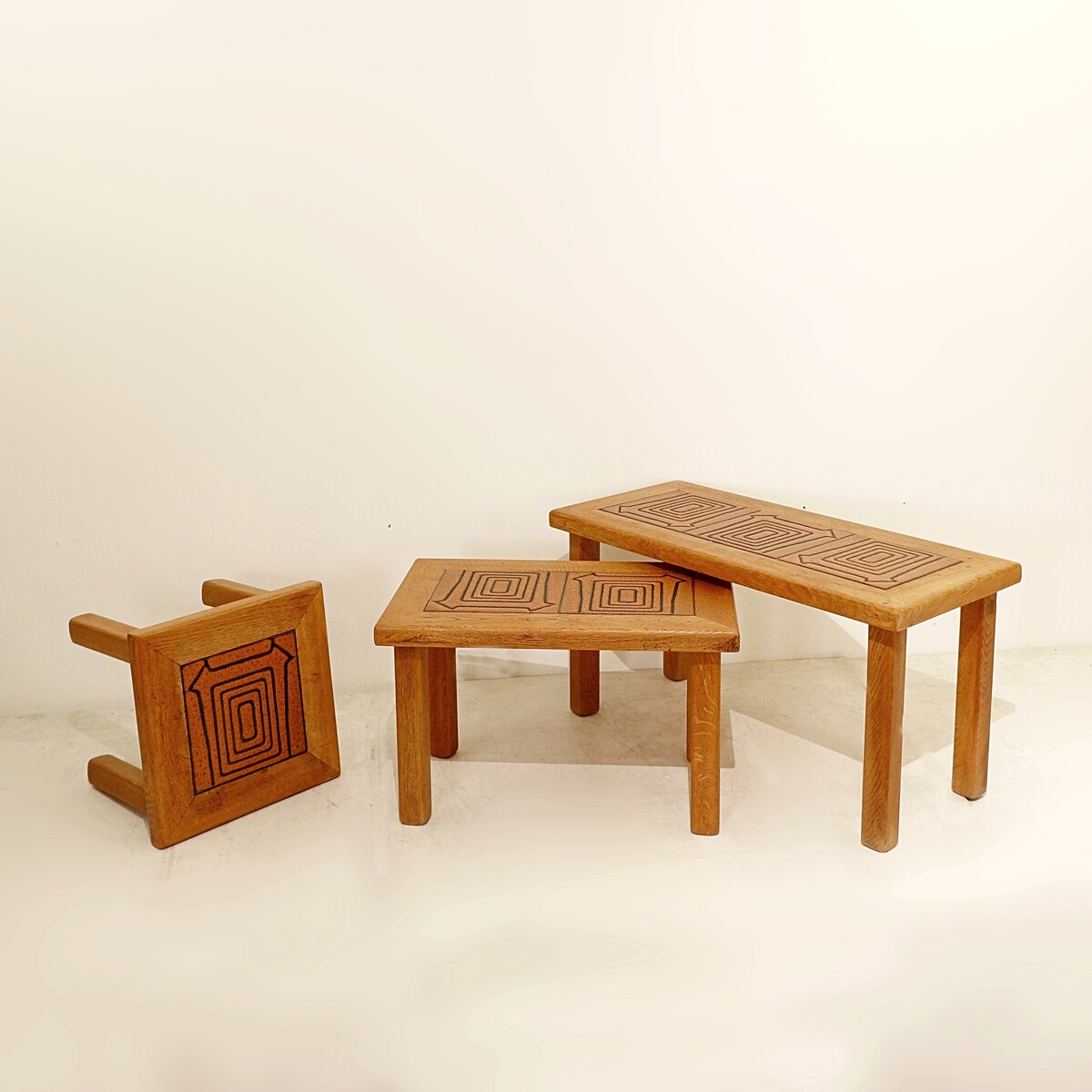 Brutalist solid oak nesting tables with geometric-patterned tiles
