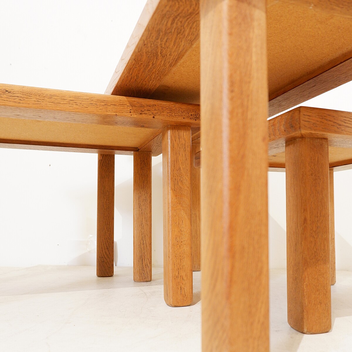 Brutalist solid oak nesting tables with geometric-patterned tiles