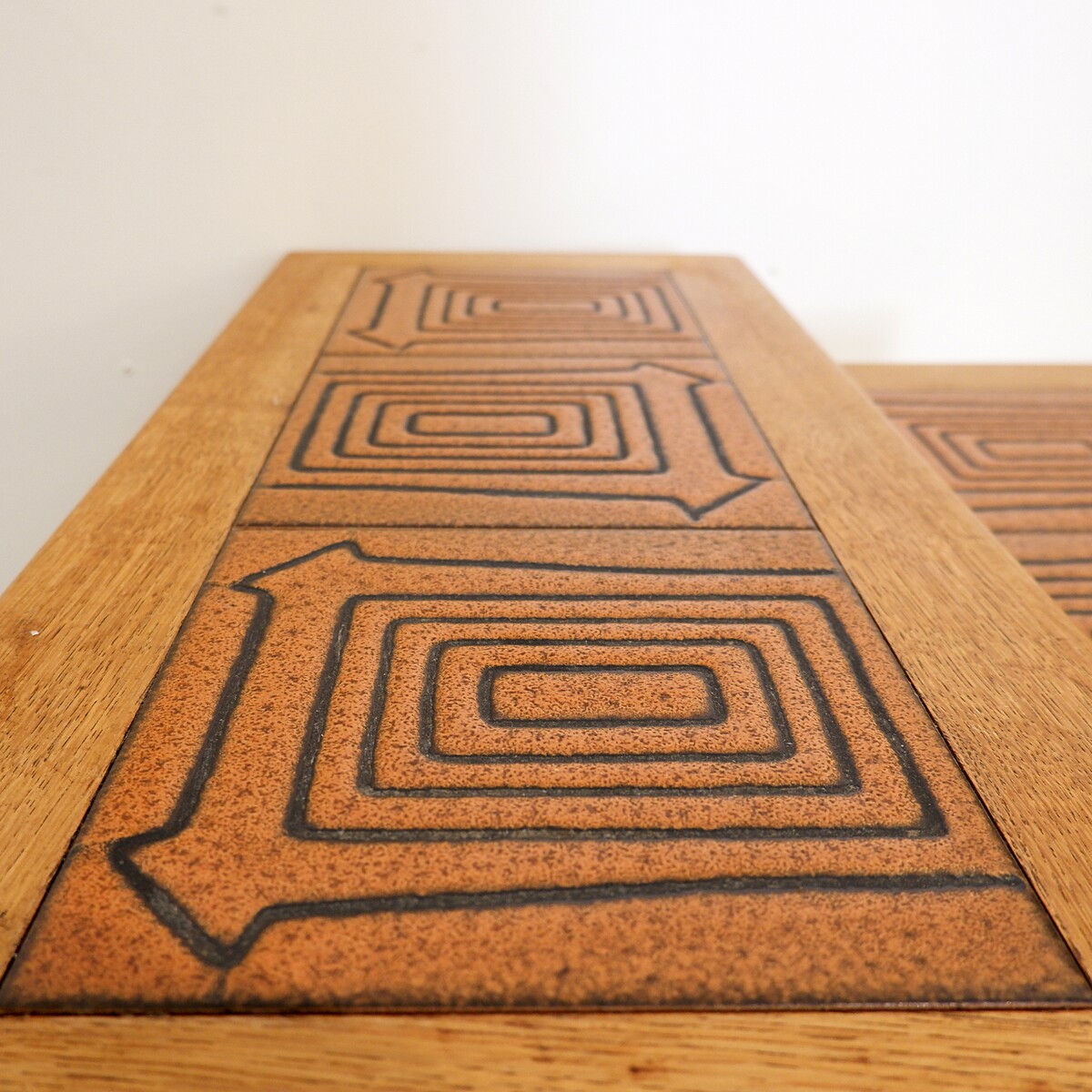 Brutalist solid oak nesting tables with geometric-patterned tiles
