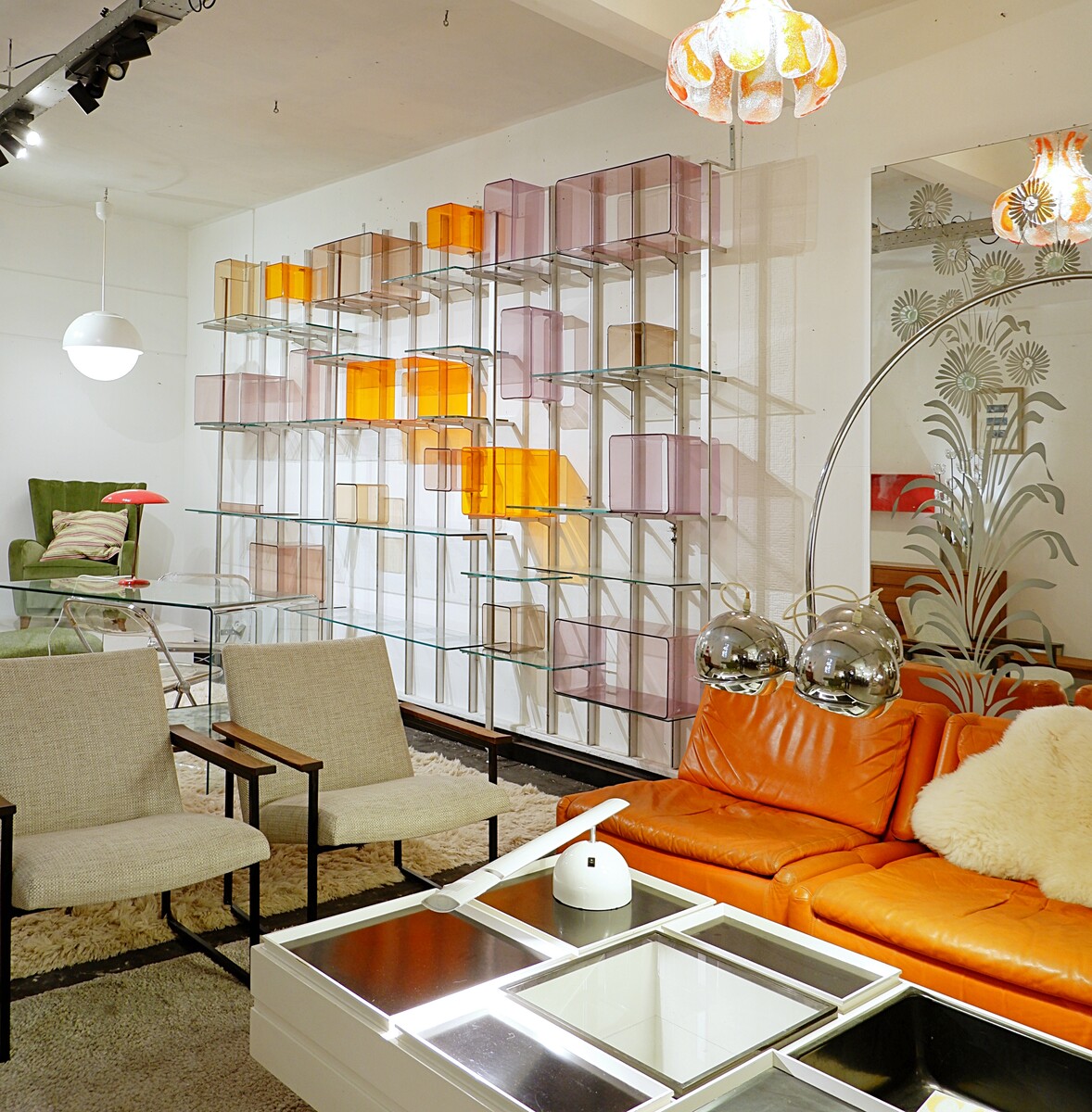 Modular wall shelf in brushed metal, glass and acrylic, in the style of Michel Ducaroy