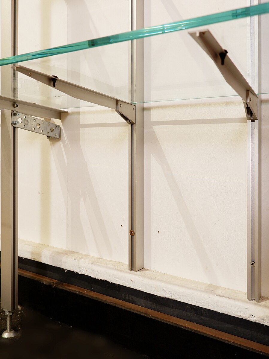 Modular wall shelf in brushed metal, glass and acrylic, in the style of Michel Ducaroy
