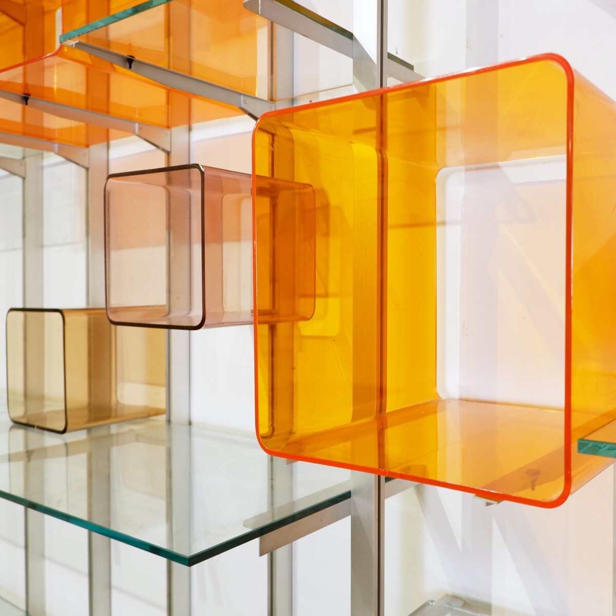 Modular wall shelf in brushed metal, glass and acrylic, in the style of Michel Ducaroy