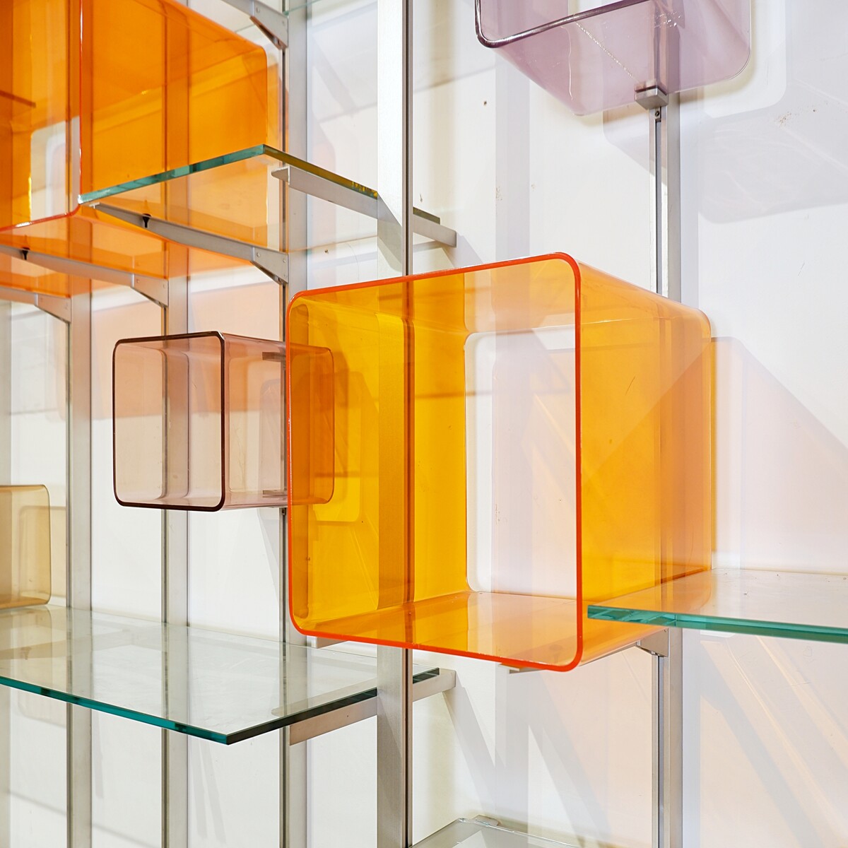 Modular wall shelf in brushed metal, glass and acrylic, in the style of Michel Ducaroy