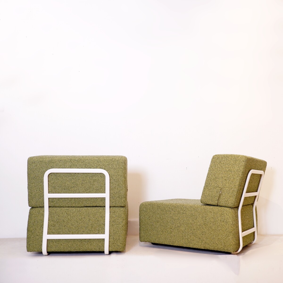 Pair of lounge chairs with white metal frame and new mottled green upholstery