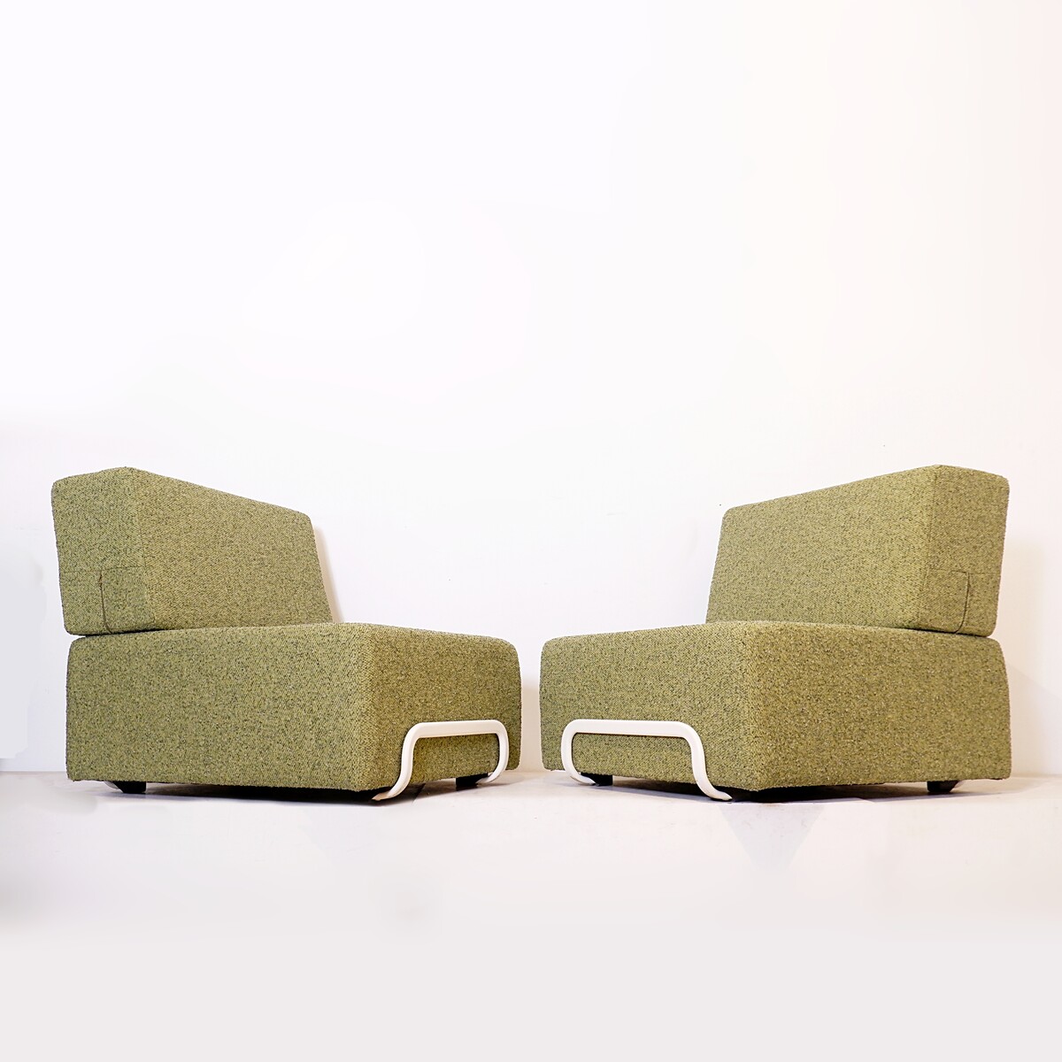 Pair of lounge chairs with white metal frame and new mottled green upholstery