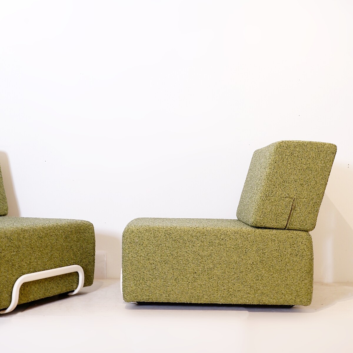 Pair of lounge chairs with white metal frame and new mottled green upholstery