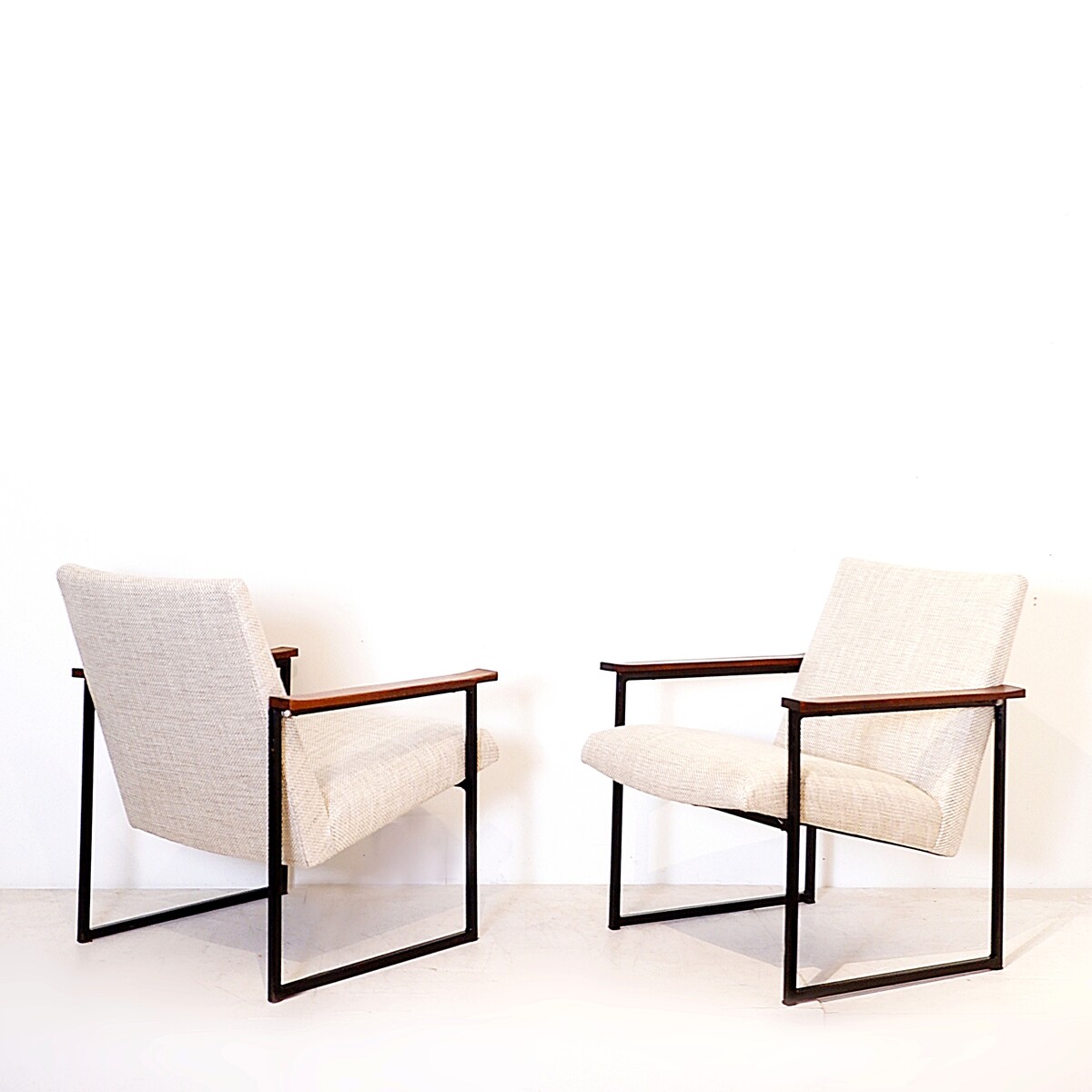 Pair of mid-century armchairs with black metal frames and wooden armrests - New Upholstery