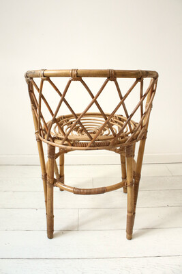 Accent chair in rattan with cane backrest, circa 1970.