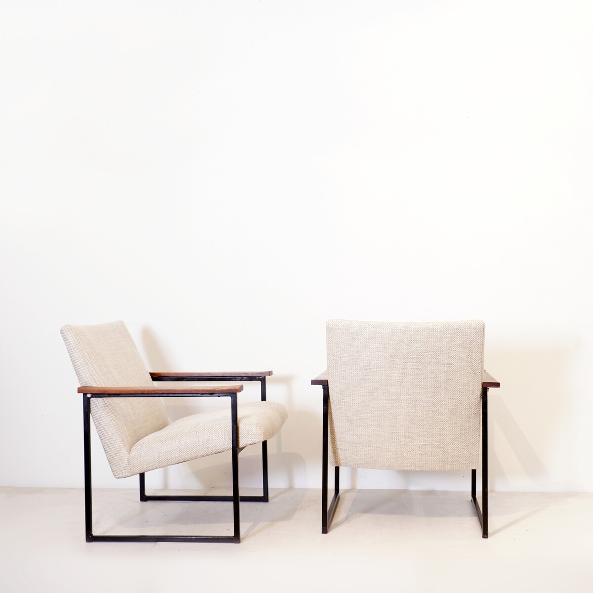 Pair of mid-century armchairs with black metal frames and wooden armrests - New Upholstery
