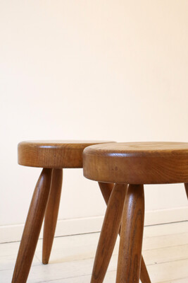 Pair of tripod stools in the style of Perriand, circa 1970s.